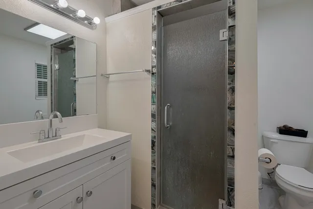 a bathroom with a sink toilet and shower