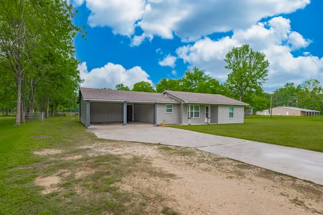 a front view of house with yard and green space