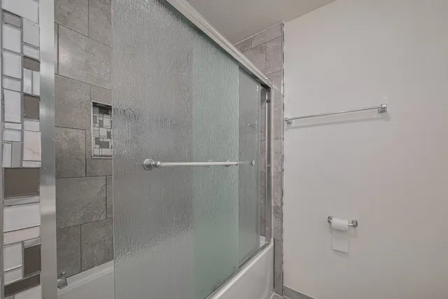 a view of a yard in front of a house with a large tree