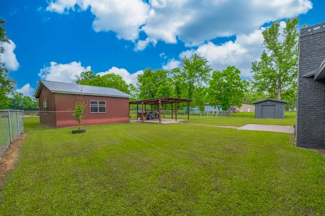 a aerial view of a house with swimming pool next to a big yard