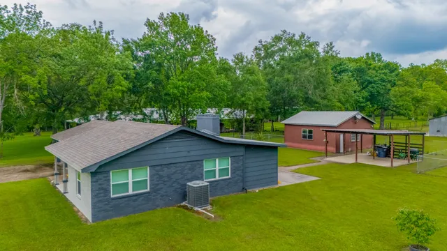 aerial view of a house with yard swimming pool and outdoor seating
