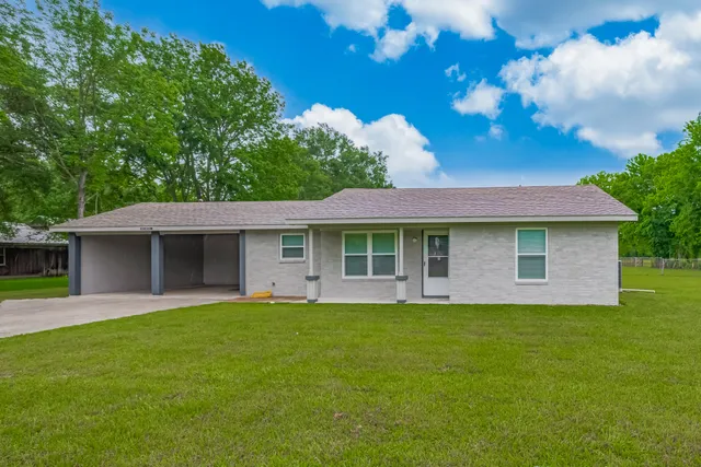 a front view of a house with a garden