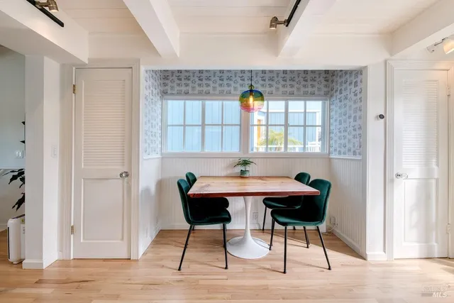 a view of a dining room with furniture window and wooden floor