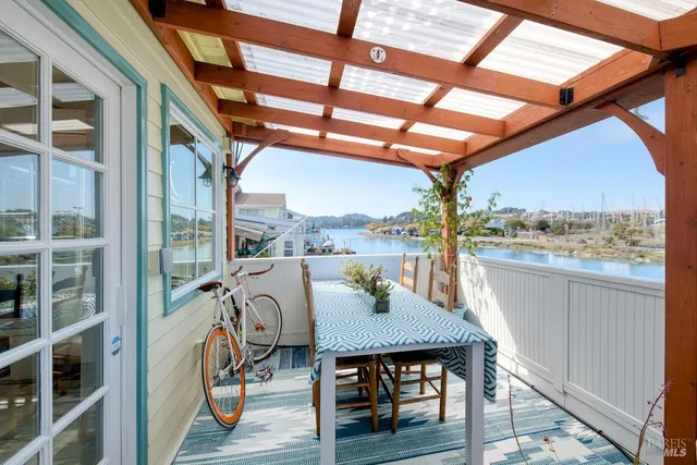 a view of a balcony with furniture and wooden floor