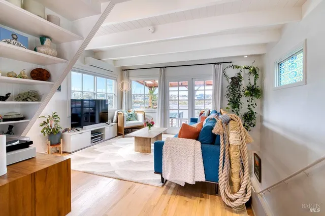 a living room with furniture and a floor to ceiling window