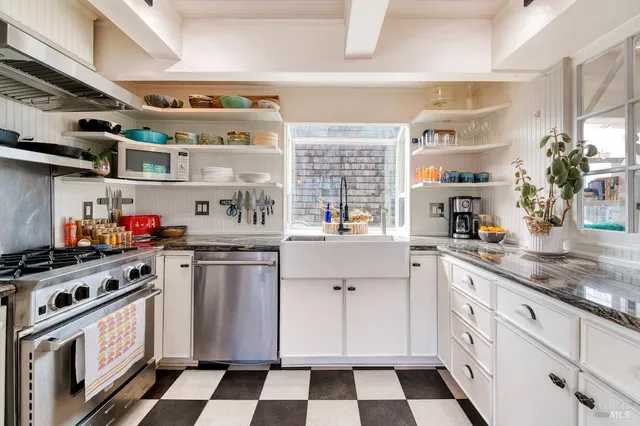 a kitchen with stainless steel appliances a sink and cabinets