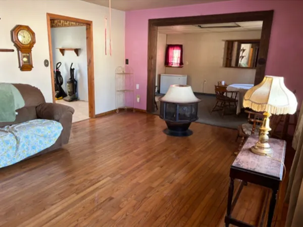 a living room with furniture a window and a wooden floor