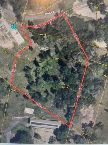 a view of a yard with wooden fence