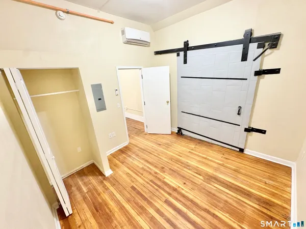 a view of a room with wooden floor