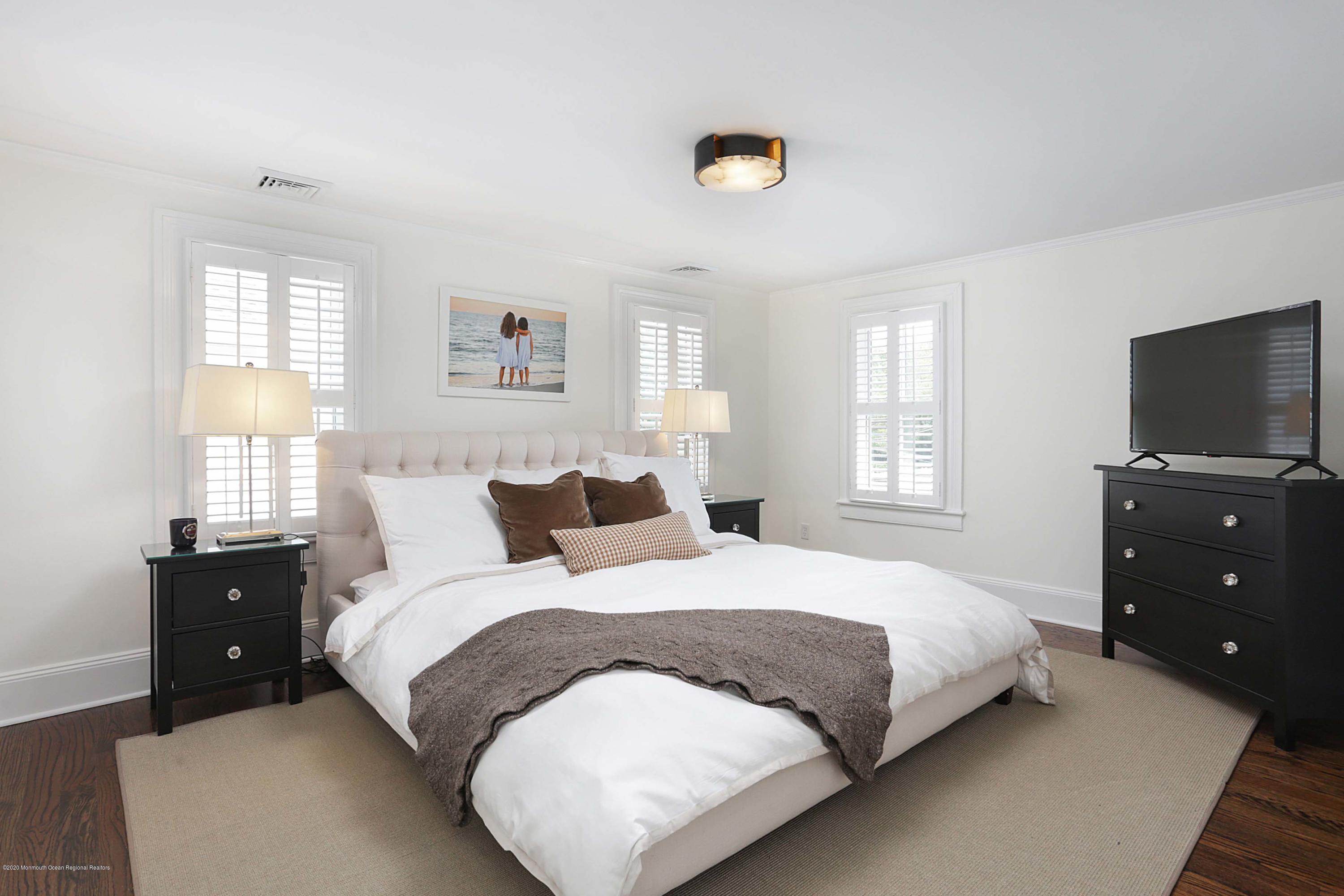 189 Rumson Road Little Silver, NJ 07739 - Photo 14 of 30 a bedroom with a bed and a tv on dresser