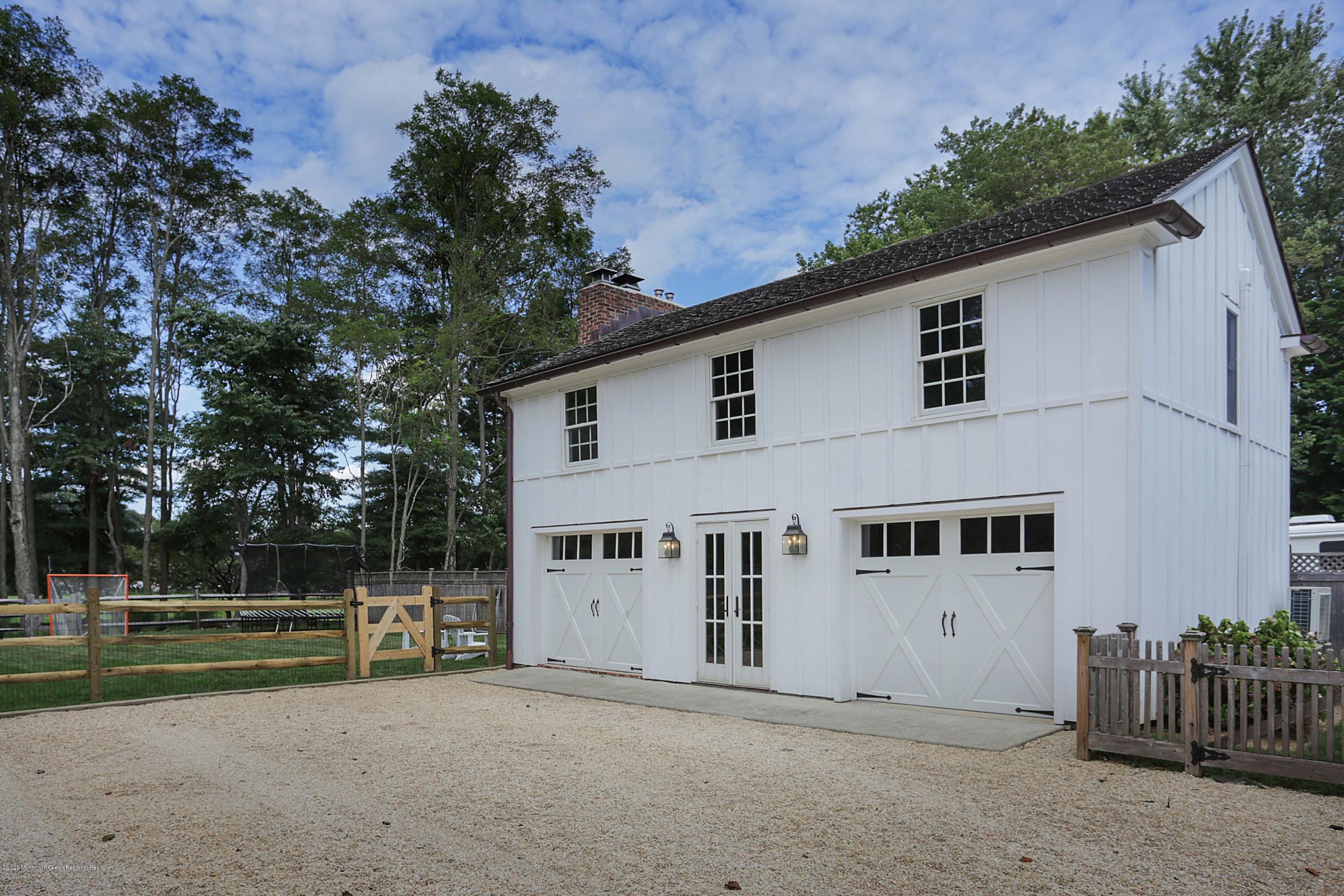 189 Rumson Road Little Silver, NJ 07739 - Photo 21 of 30 a view of a white house with large trees and wooden fence