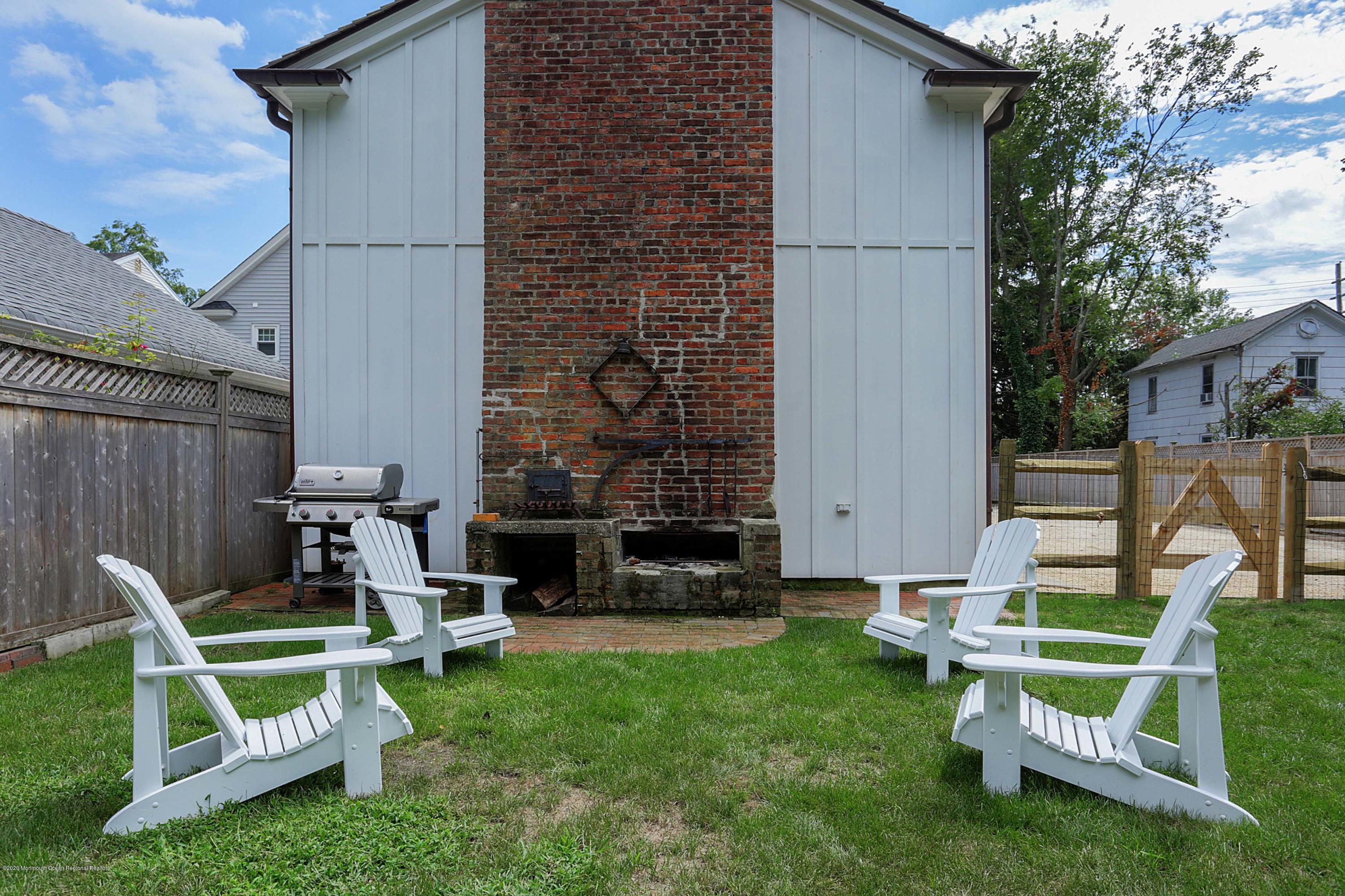 189 Rumson Road Little Silver, NJ 07739 - Photo 23 of 30 a view of a chair and table in backyard of the house