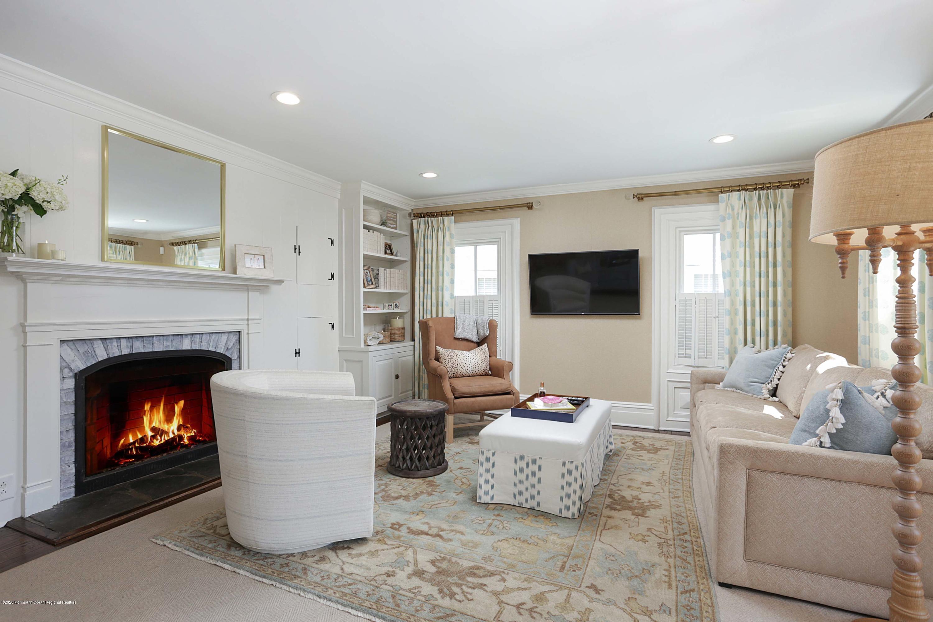 189 Rumson Road Little Silver, NJ 07739 - Photo 6 of 30 a living room with furniture a fireplace and a flat screen tv