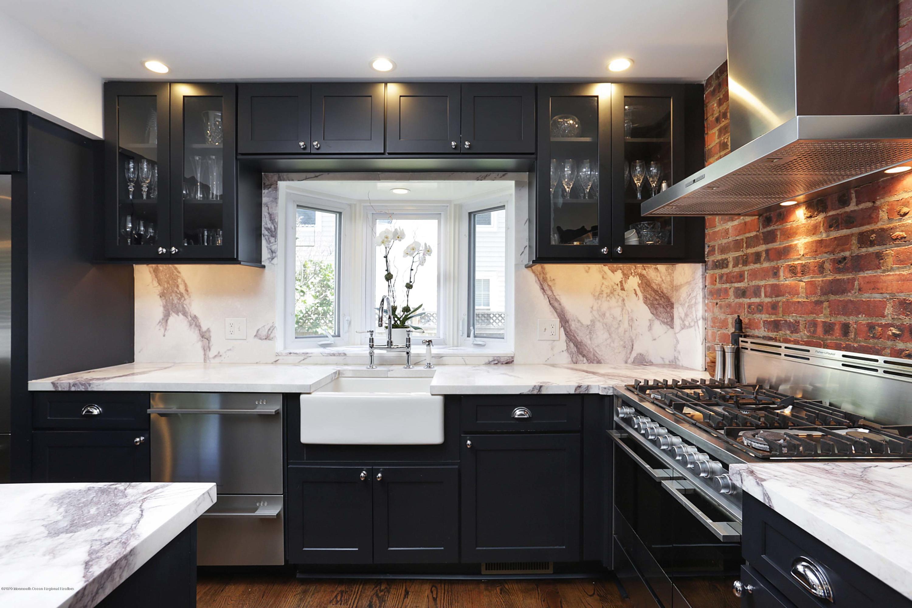 189 Rumson Road Little Silver, NJ 07739 - Photo 9 of 30 a kitchen with a sink a stove and cabinets