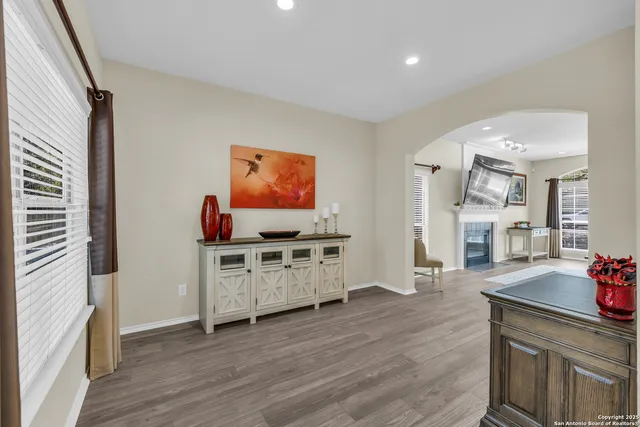 a kitchen with stainless steel appliances a stove top oven and a wooden floor
