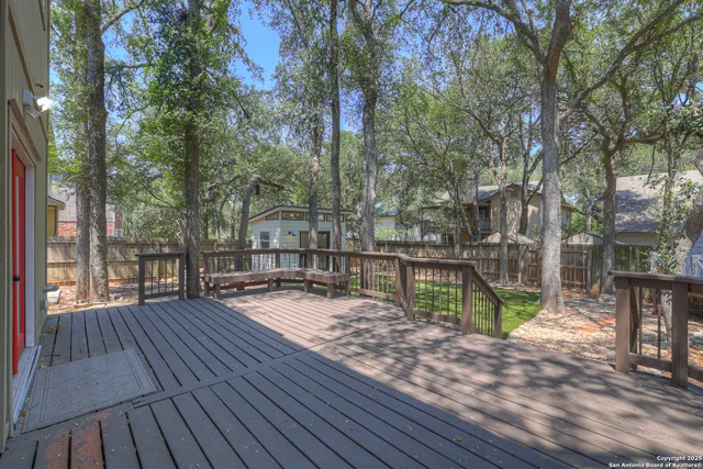 a view of house with deck and outdoor space