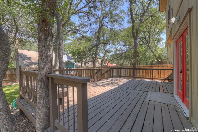 a view of balcony with wooden floor and fence