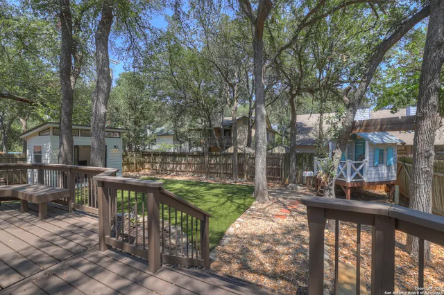 a view of a patio with table and chairs and potted plants