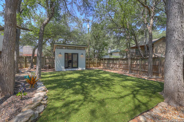 a view of an house with backyard space and balcony