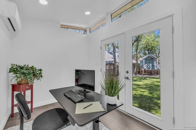 a view of a workspace with furniture and a potted plant