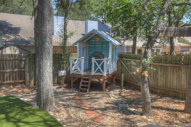 a wooden bench sitting in front of a house