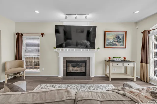 a living room with furniture and a fireplace