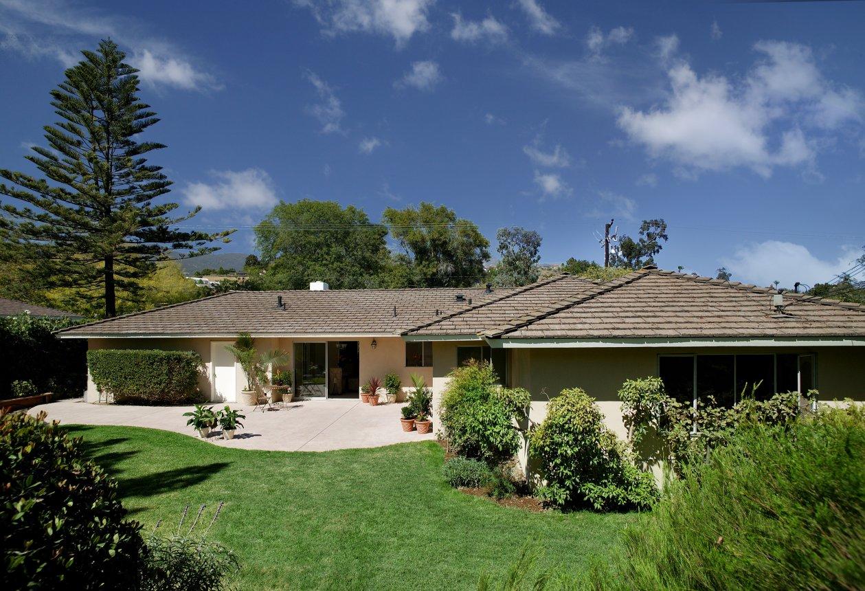 a front view of a house with a garden