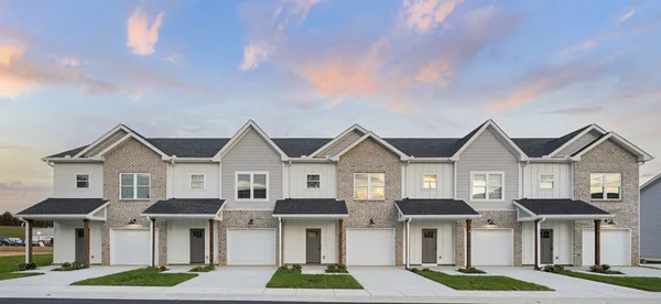 a front view of a residential houses with yard