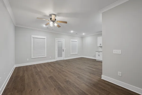 a view of empty room with wooden floor