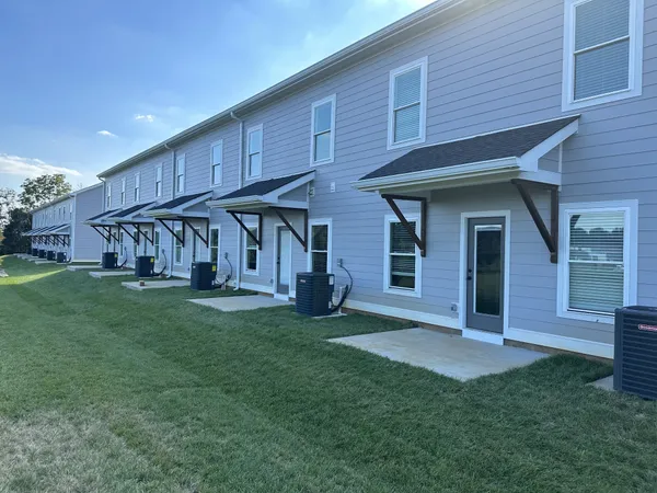 a view of a house with backyard and porch