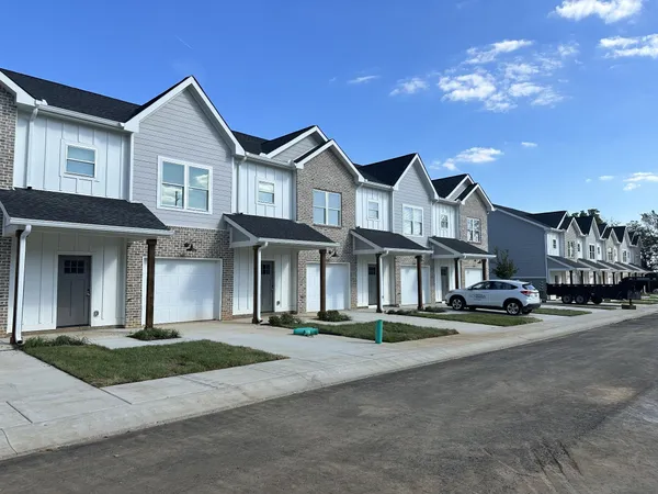 a front view of a residential houses with yard