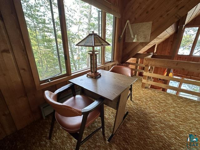 2763 Van Vac Road Ely, MN 55731 - Photo 24 of 37 Loft area featuring sloped wood-paneled walls and ceiling, large windows, and a carpeted floor