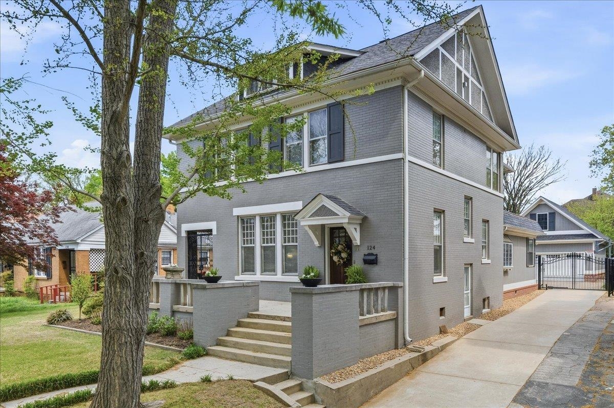 124 Clark Place Memphis, TN 38104 - Photo 1 of 40 a view of a white house with large windows and a small yard