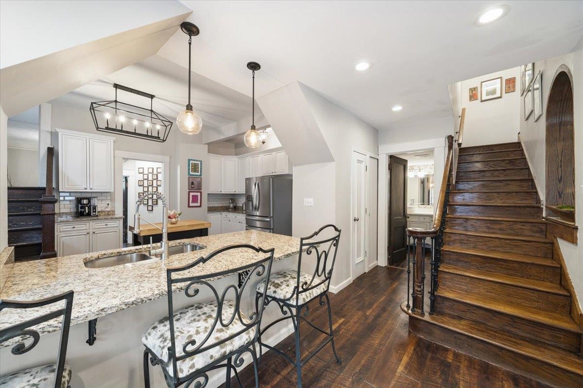 124 Clark Place Memphis, TN 38104 - Photo 12 of 40 a view of a dining room and livingroom with furniture wooden floor a chandelier