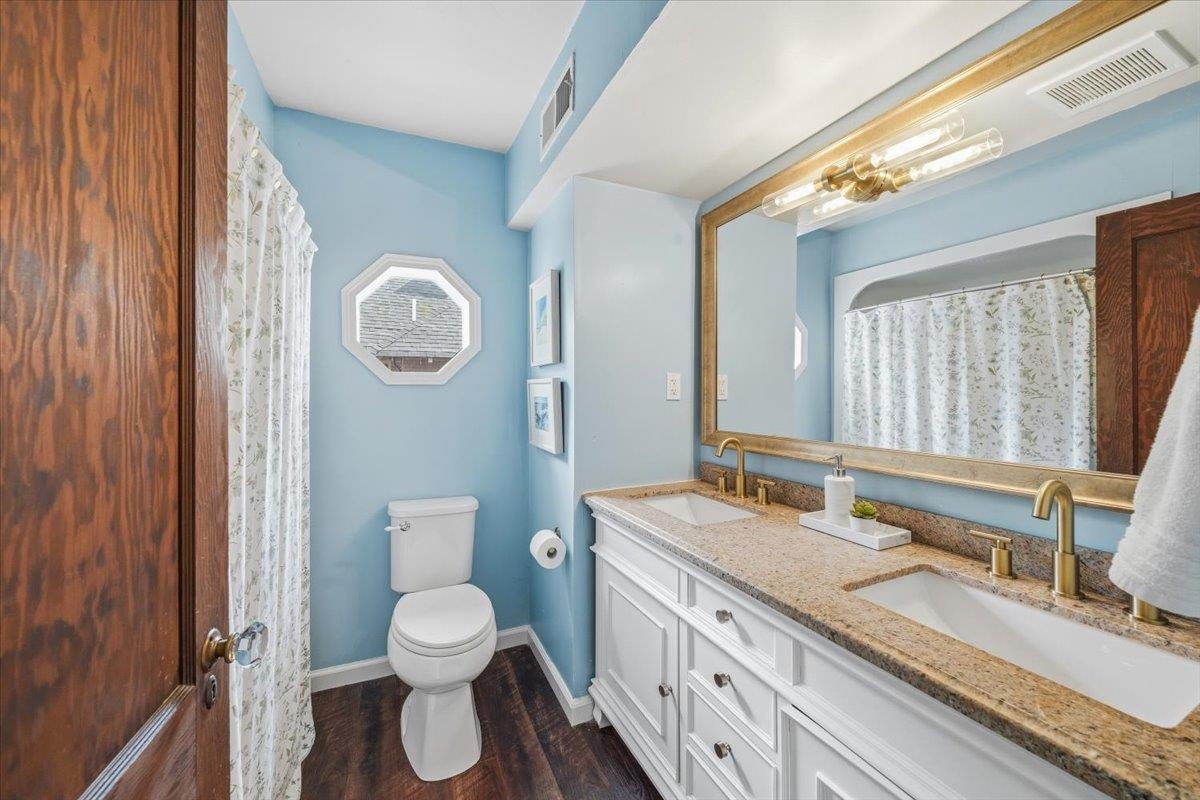 124 Clark Place Memphis, TN 38104 - Photo 27 of 40 a bathroom with a granite countertop toilet sink and mirror