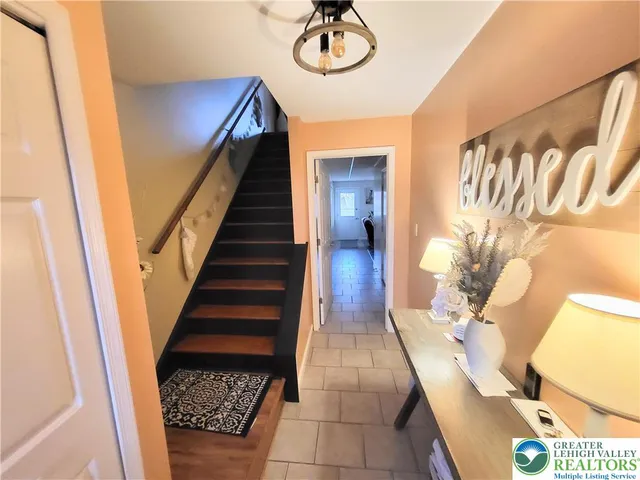 a view of entryway and hall with wooden floor