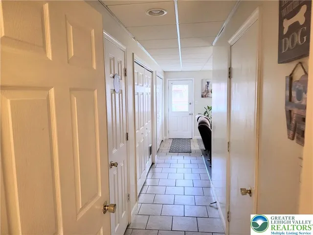 a hallway with sliding door and stairs