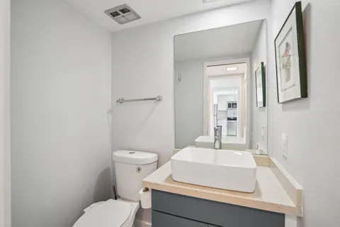 a bathroom with a sink toilet and mirror