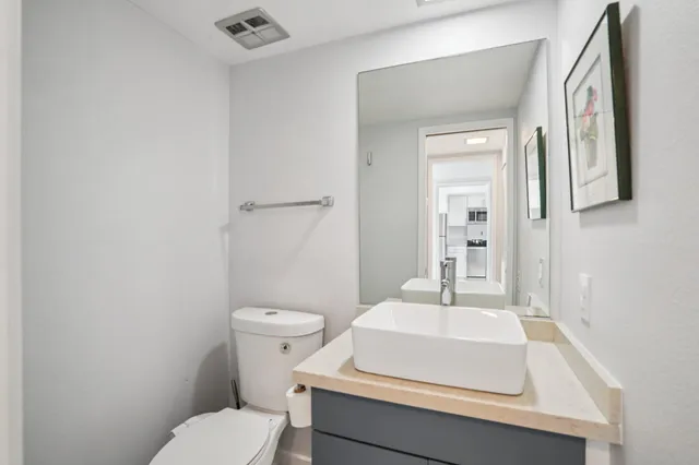 a bathroom with a sink toilet and mirror
