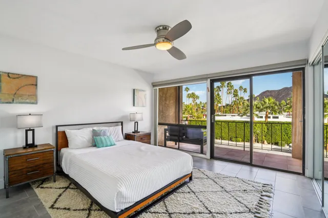 a bedroom with a large bed and a large window