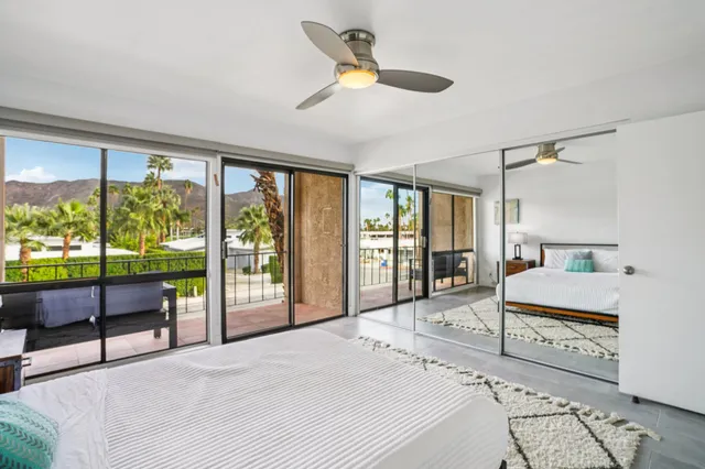 a bedroom with a large bed and a large window