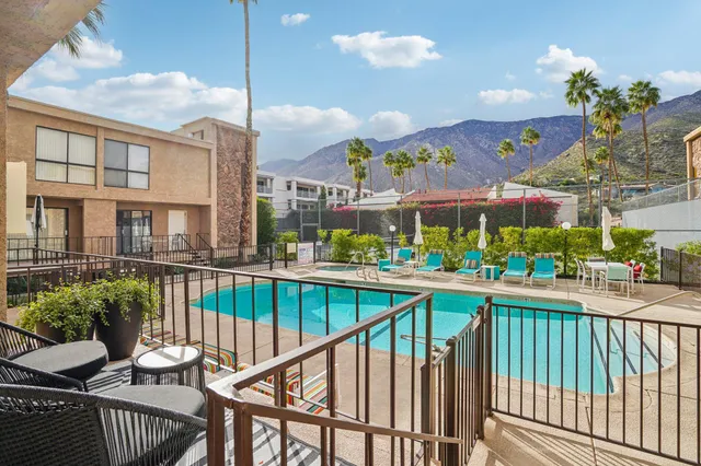 a view of a porch and yard from a balcony