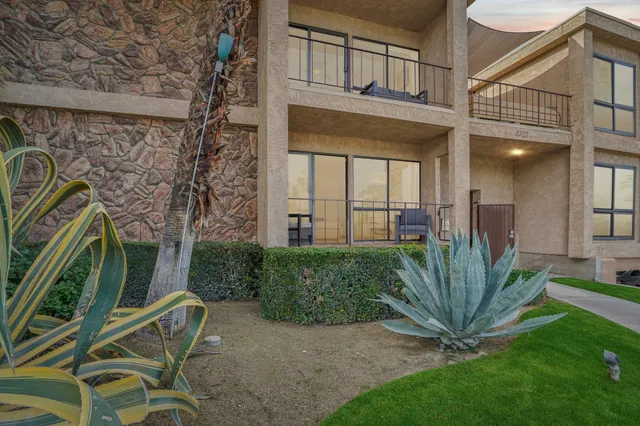 a view of a house with a small yard and plants