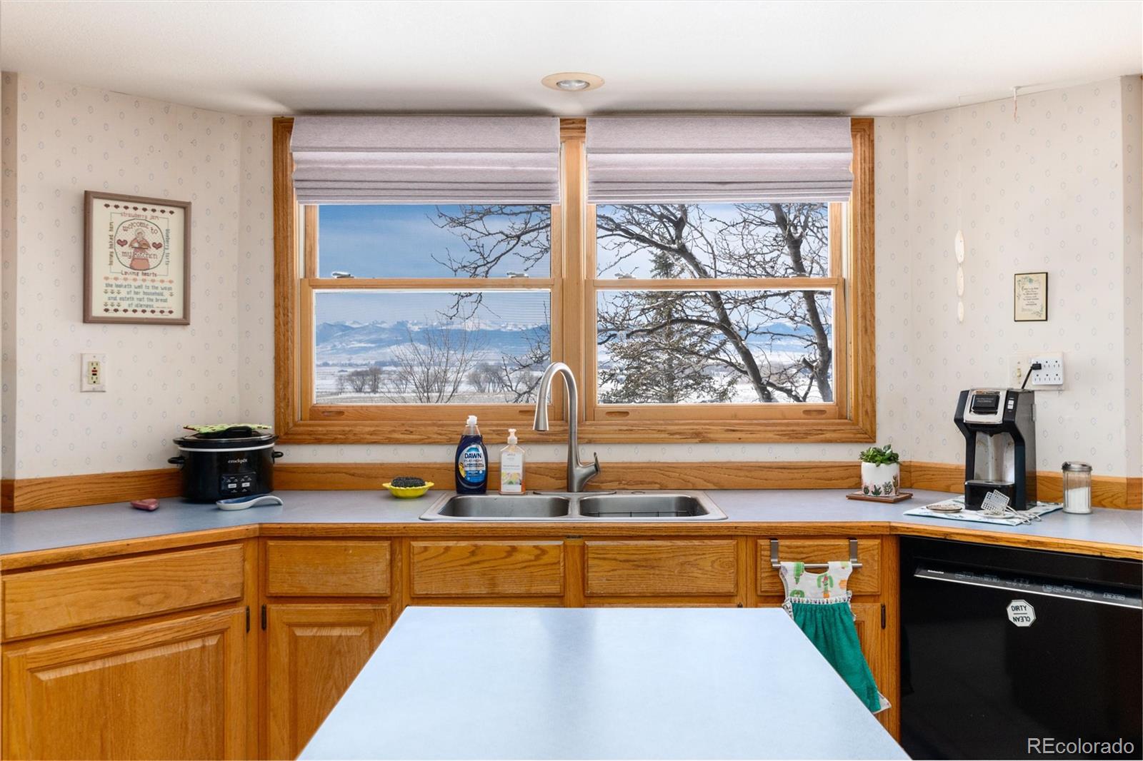 10650 Yellowstone Road Longmont, CO 80504 - Photo 12 of 43 a kitchen with sink a large window and a counter top space
