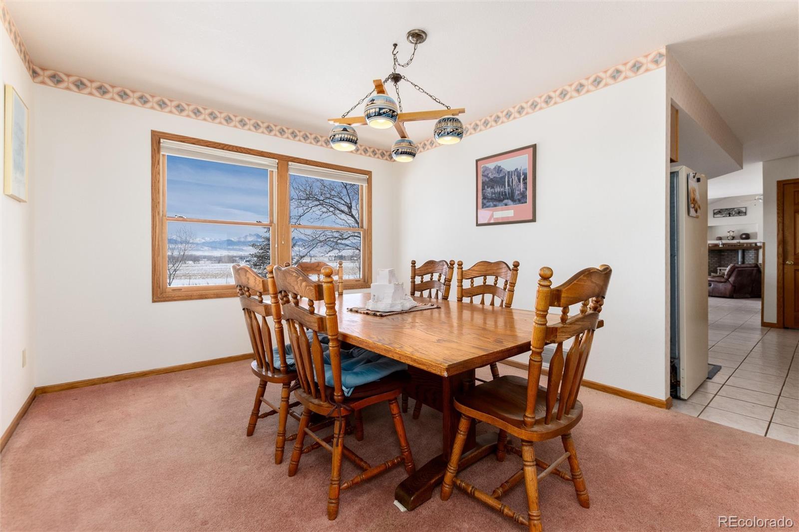 10650 Yellowstone Road Longmont, CO 80504 - Photo 14 of 43 a view of a dining room with furniture window and wooden floor