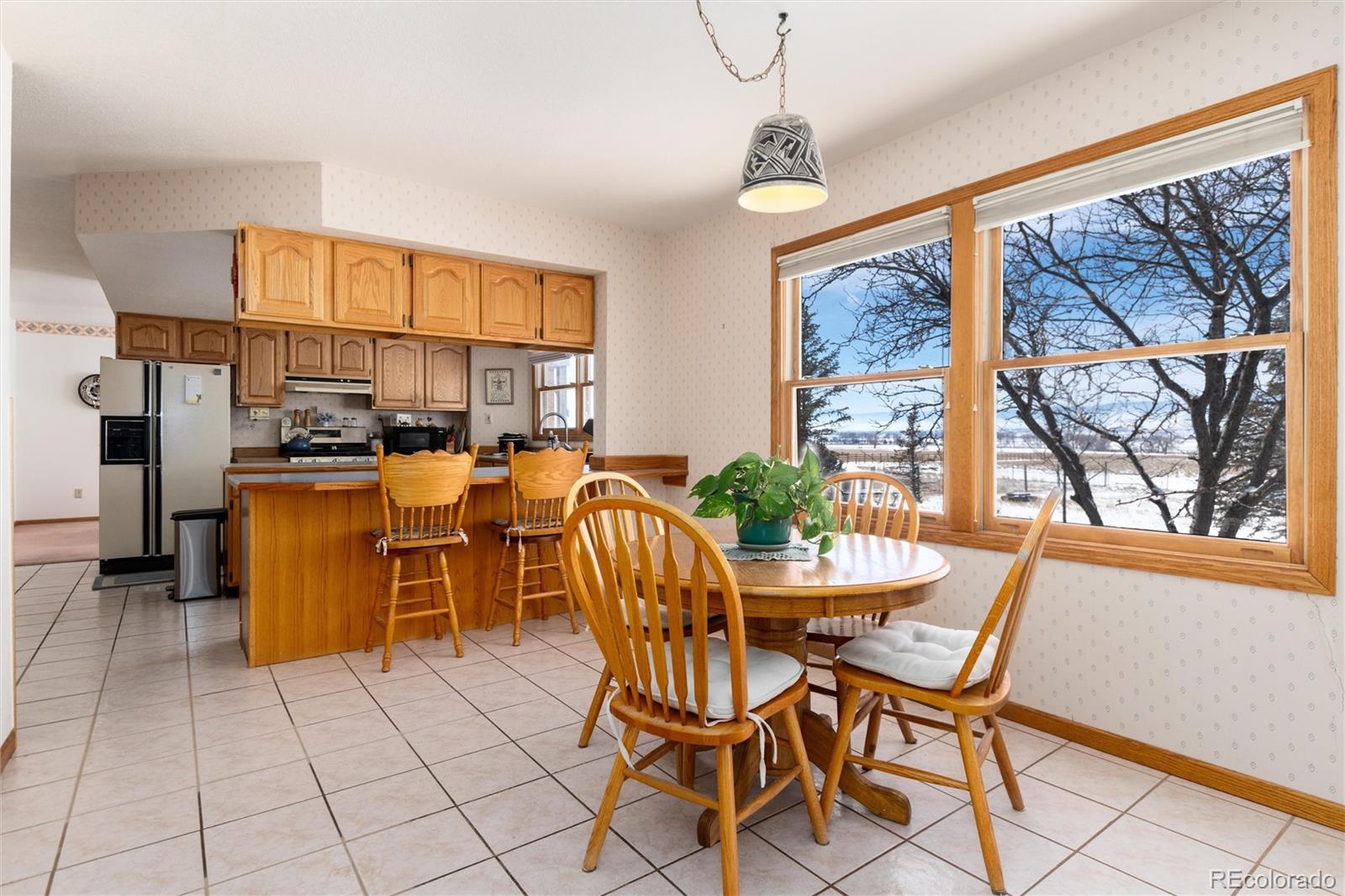 10650 Yellowstone Road Longmont, CO 80504 - Photo 15 of 43 a dining room with furniture a chandelier and window