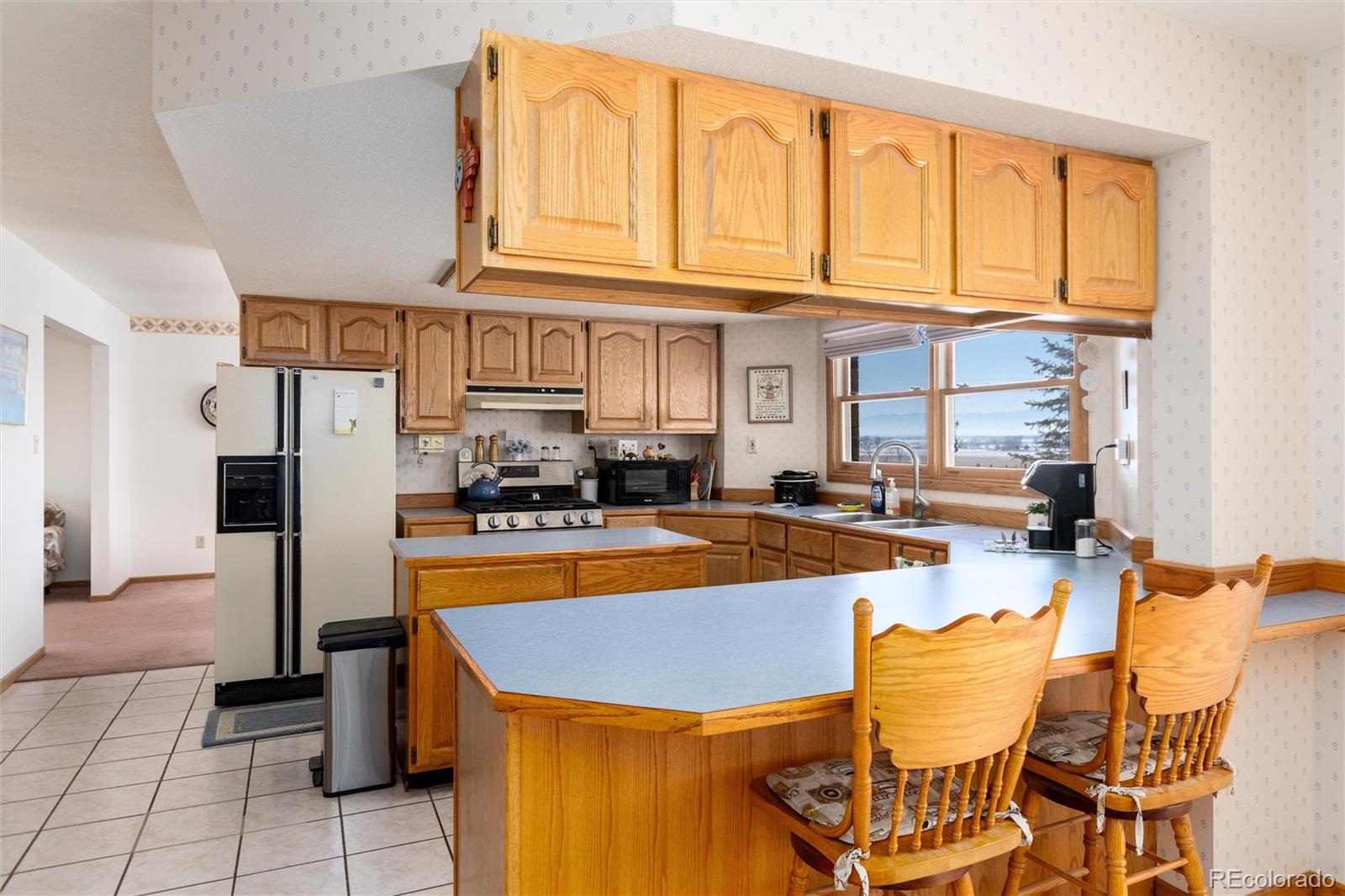 10650 Yellowstone Road Longmont, CO 80504 - Photo 16 of 43 a view of a kitchen with dining table and chairs