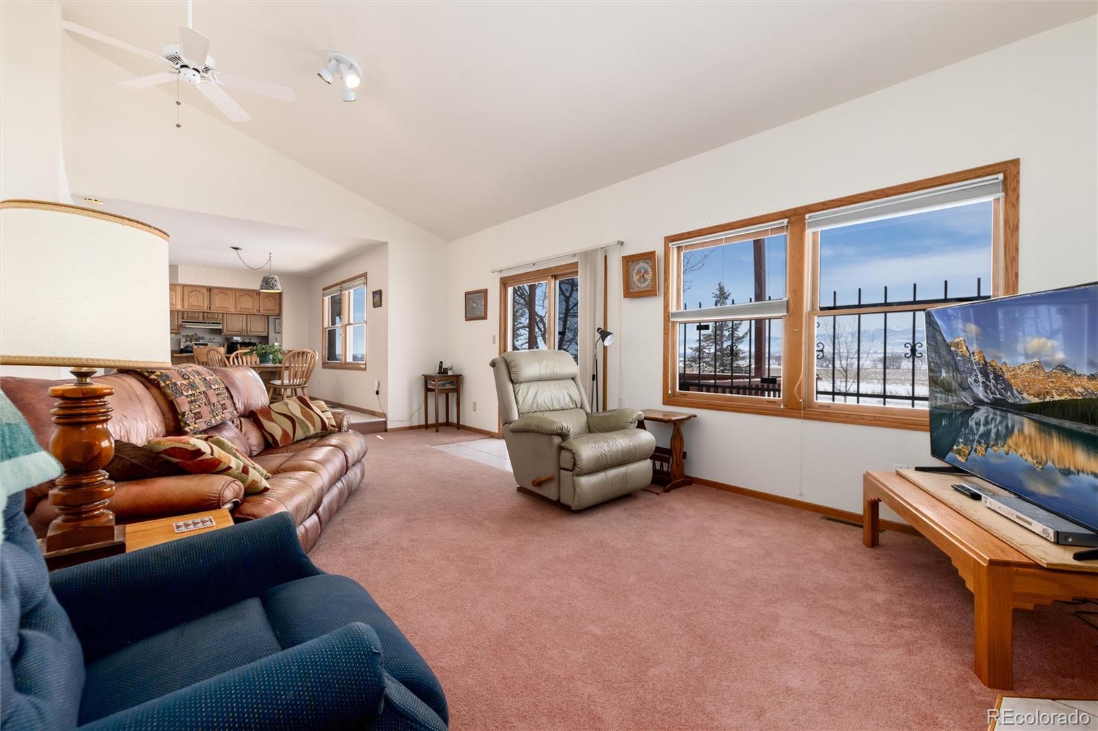 10650 Yellowstone Road Longmont, CO 80504 - Photo 19 of 43 a living room with furniture a ceiling fan and a window
