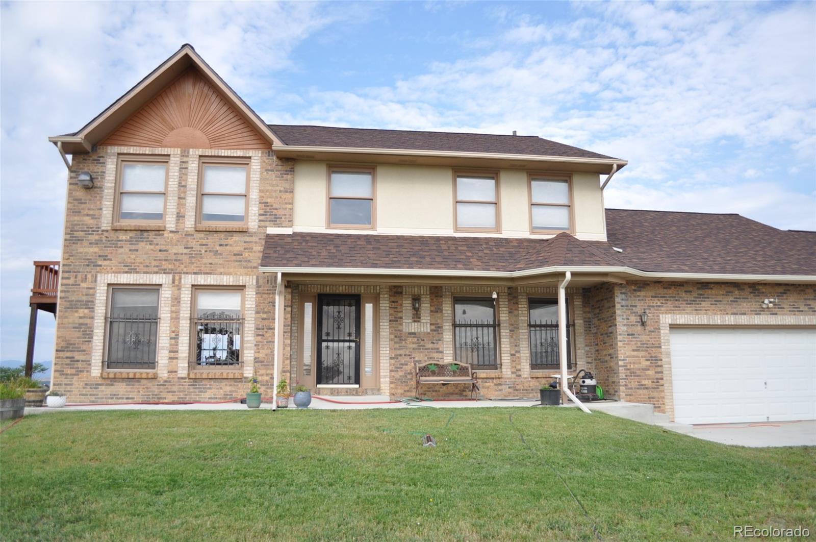 10650 Yellowstone Road Longmont, CO 80504 - Photo 2 of 43 front view of a house with a yard