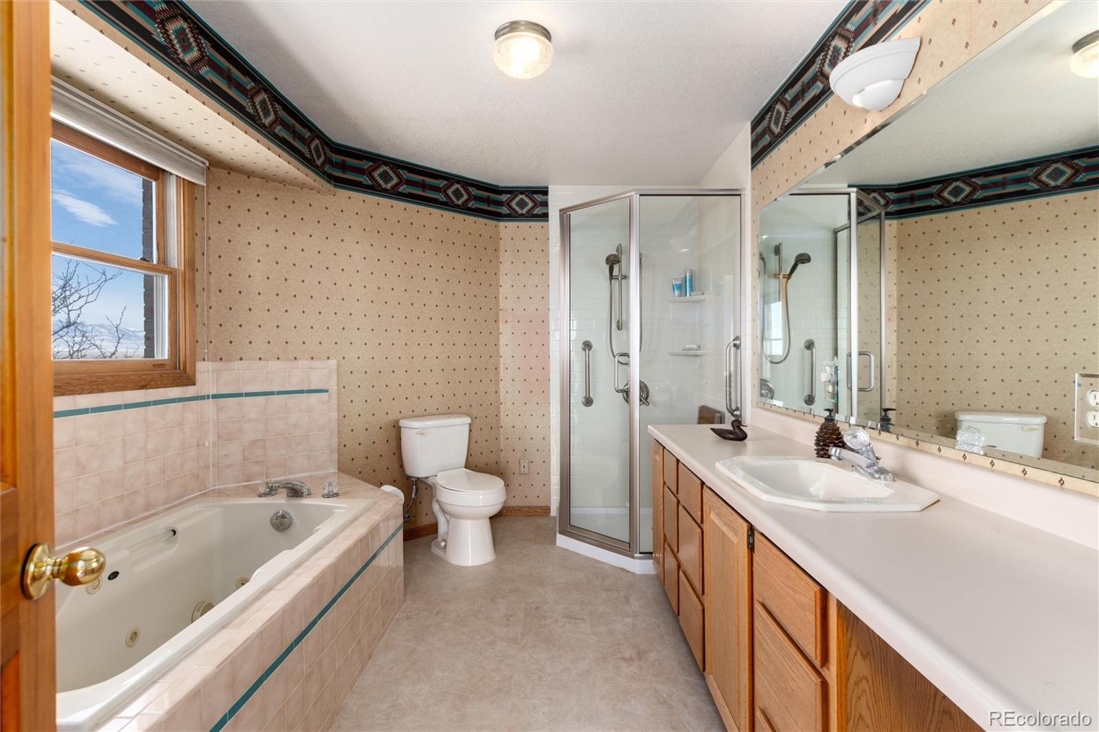 10650 Yellowstone Road Longmont, CO 80504 - Photo 23 of 43 a bathroom with a double vanity sink toilet mirror and bathtub